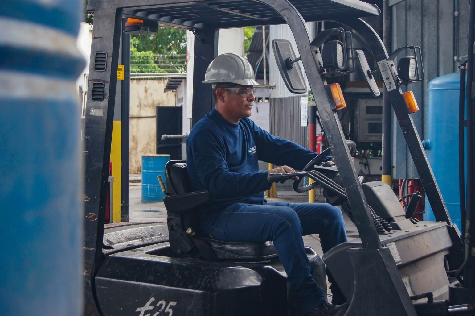 Forklift operator working in a warehouse, illustrating the learning curve and operational productivity.